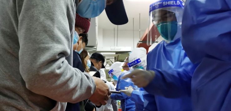 a group of people wearing face masks and gloves