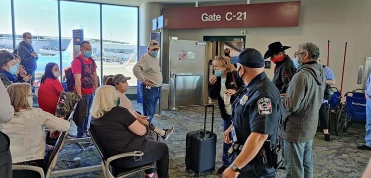 a group of people in a line at an airport