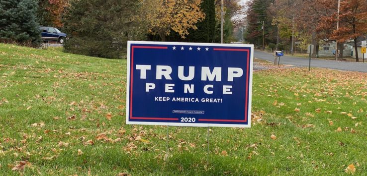 a sign in a grass field