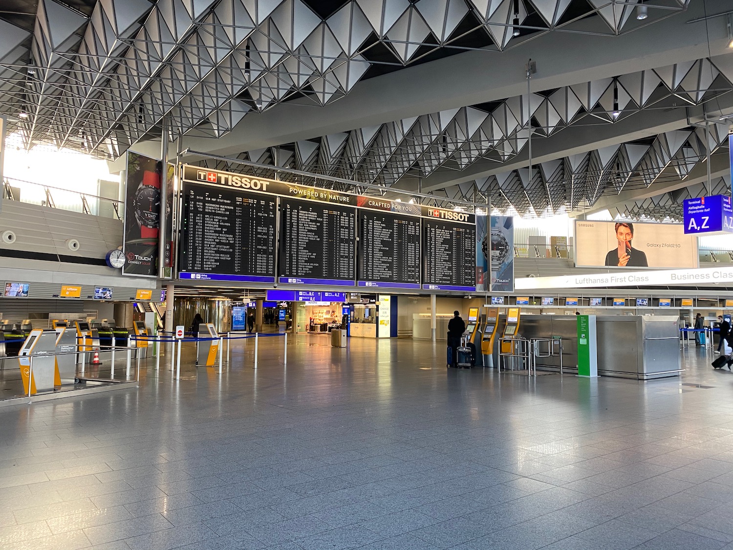 a large airport terminal with a large sign board