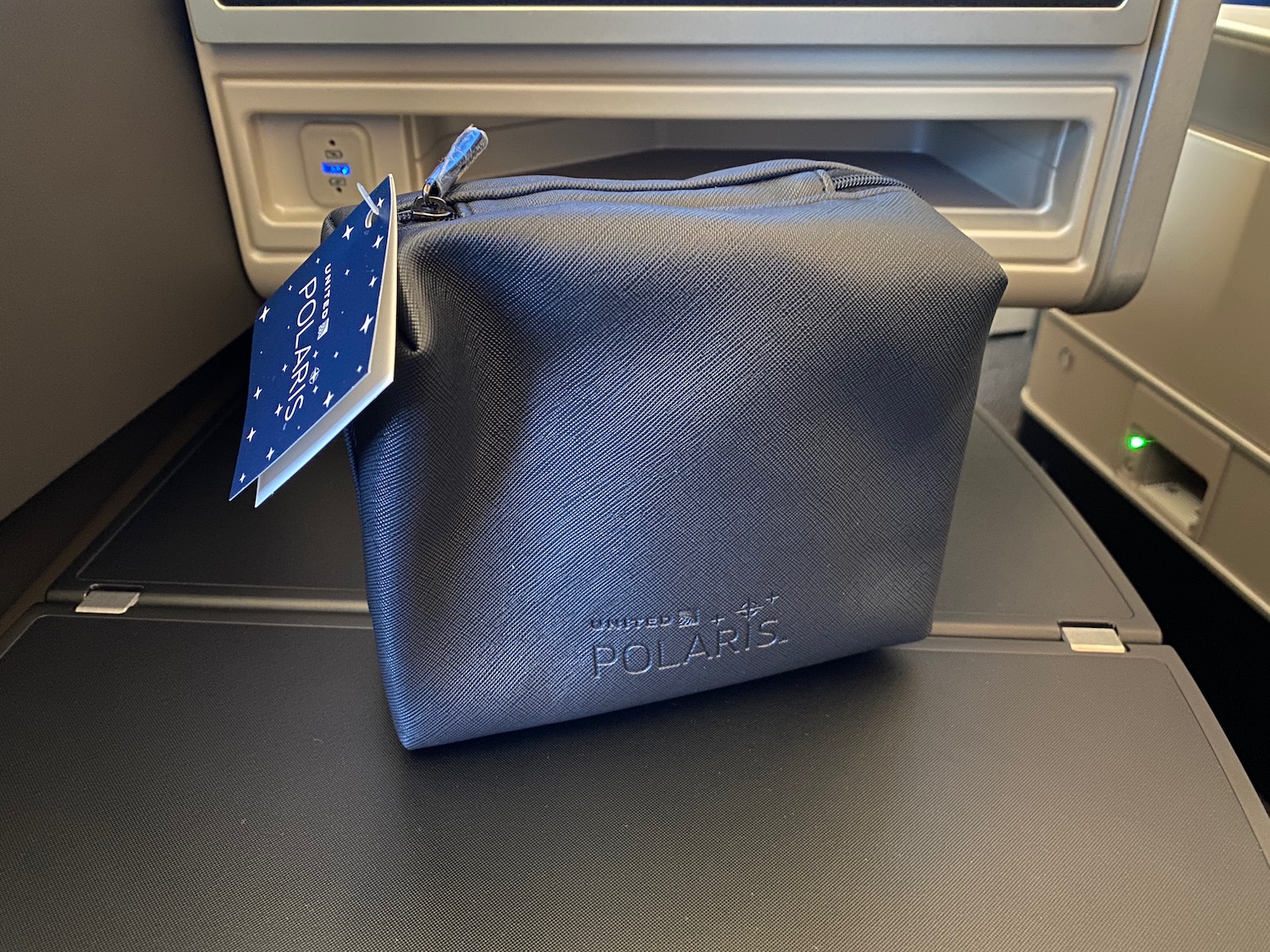 a small blue bag on a seat