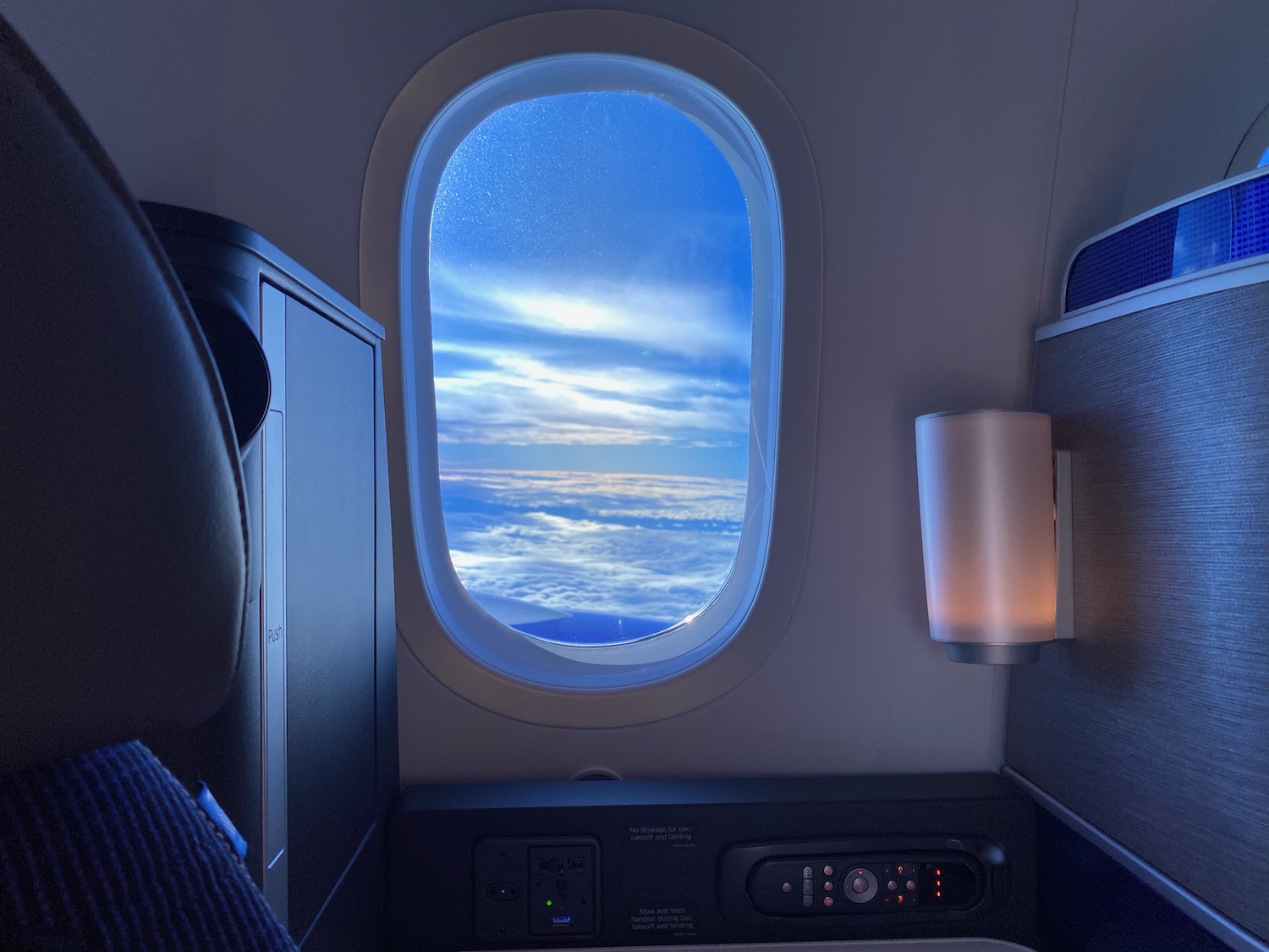 a window with a view of clouds and sky