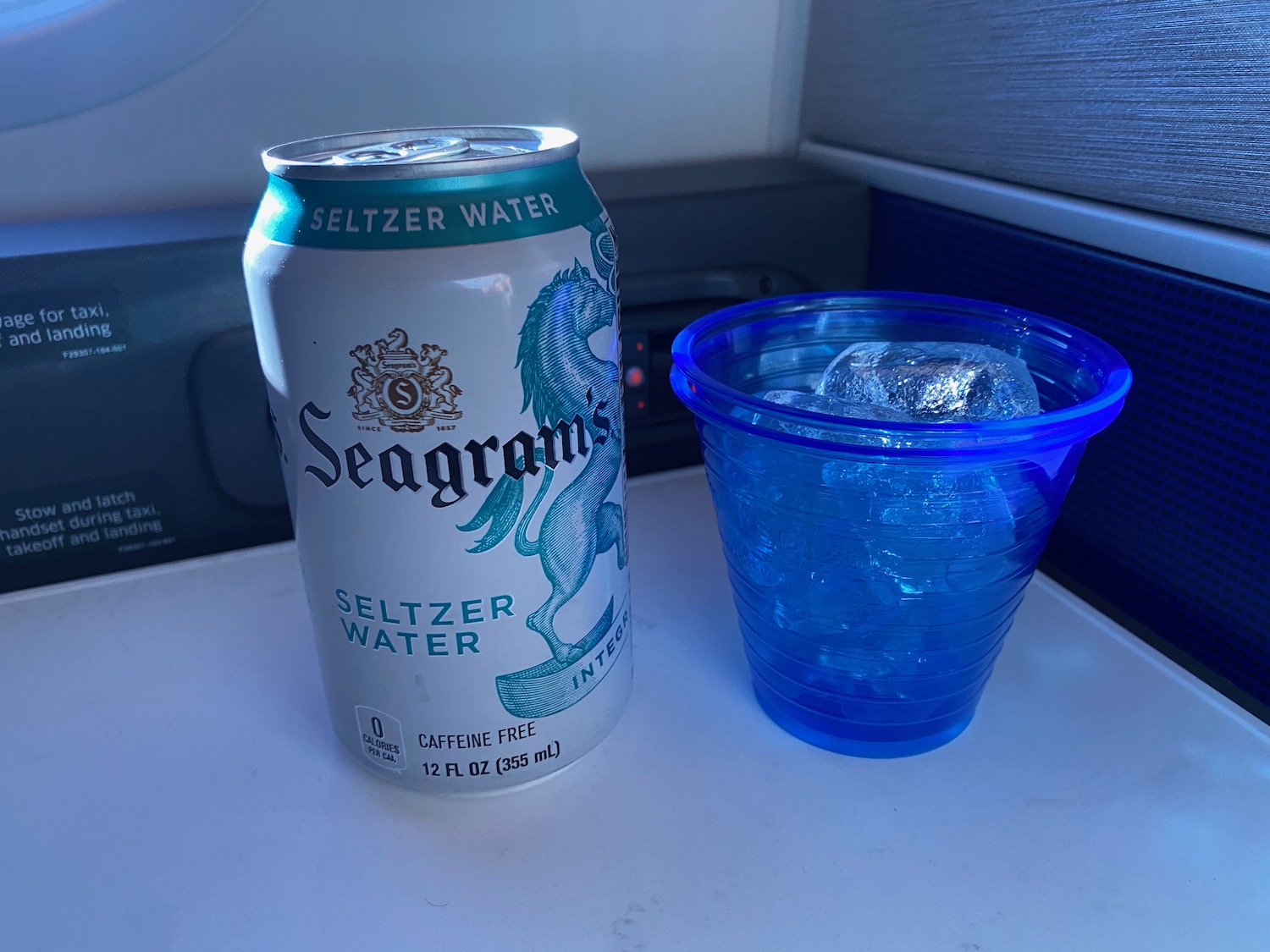 a can of seltzer water and a cup of ice