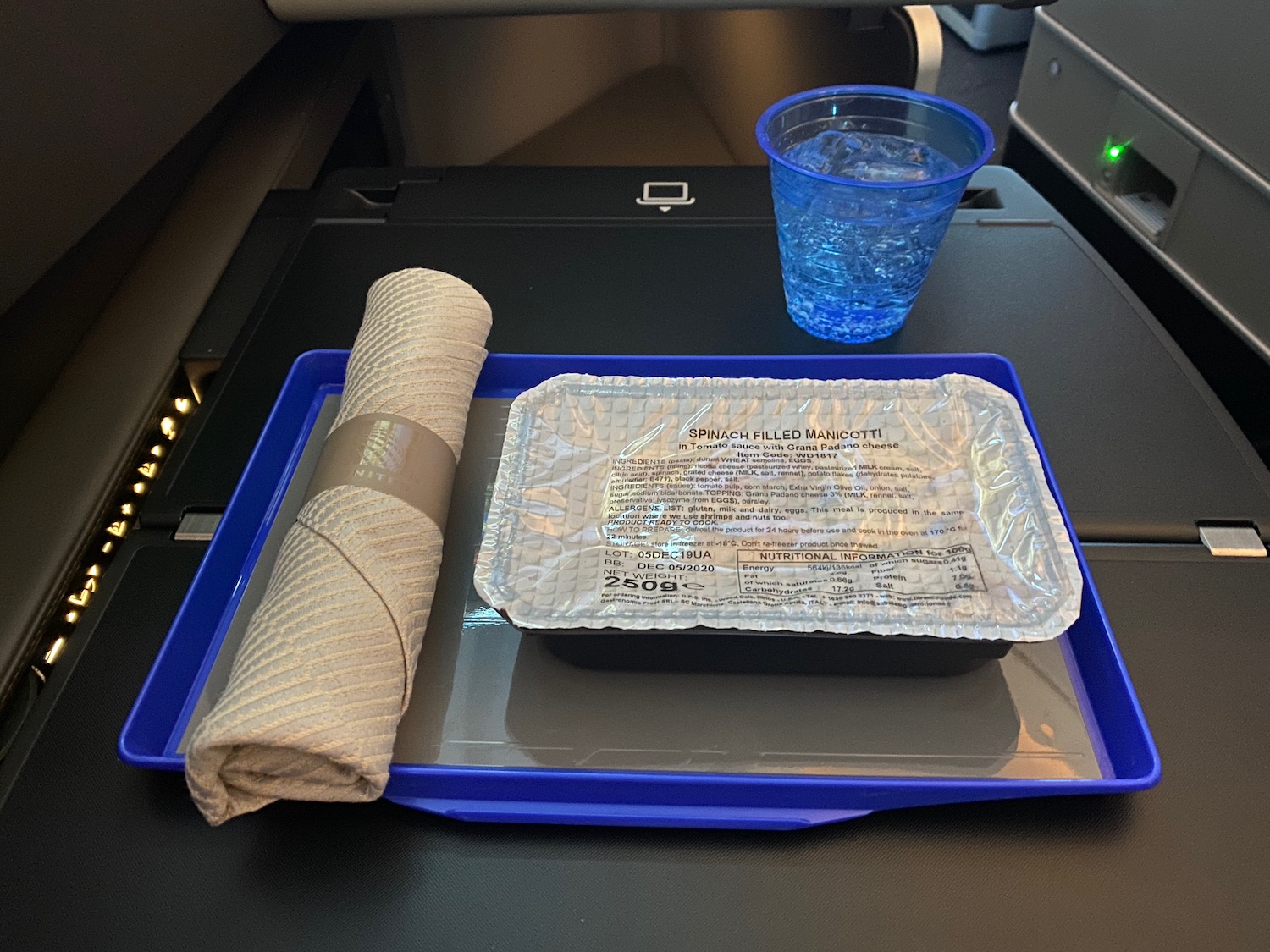 a tray of food and a glass of water on a tray