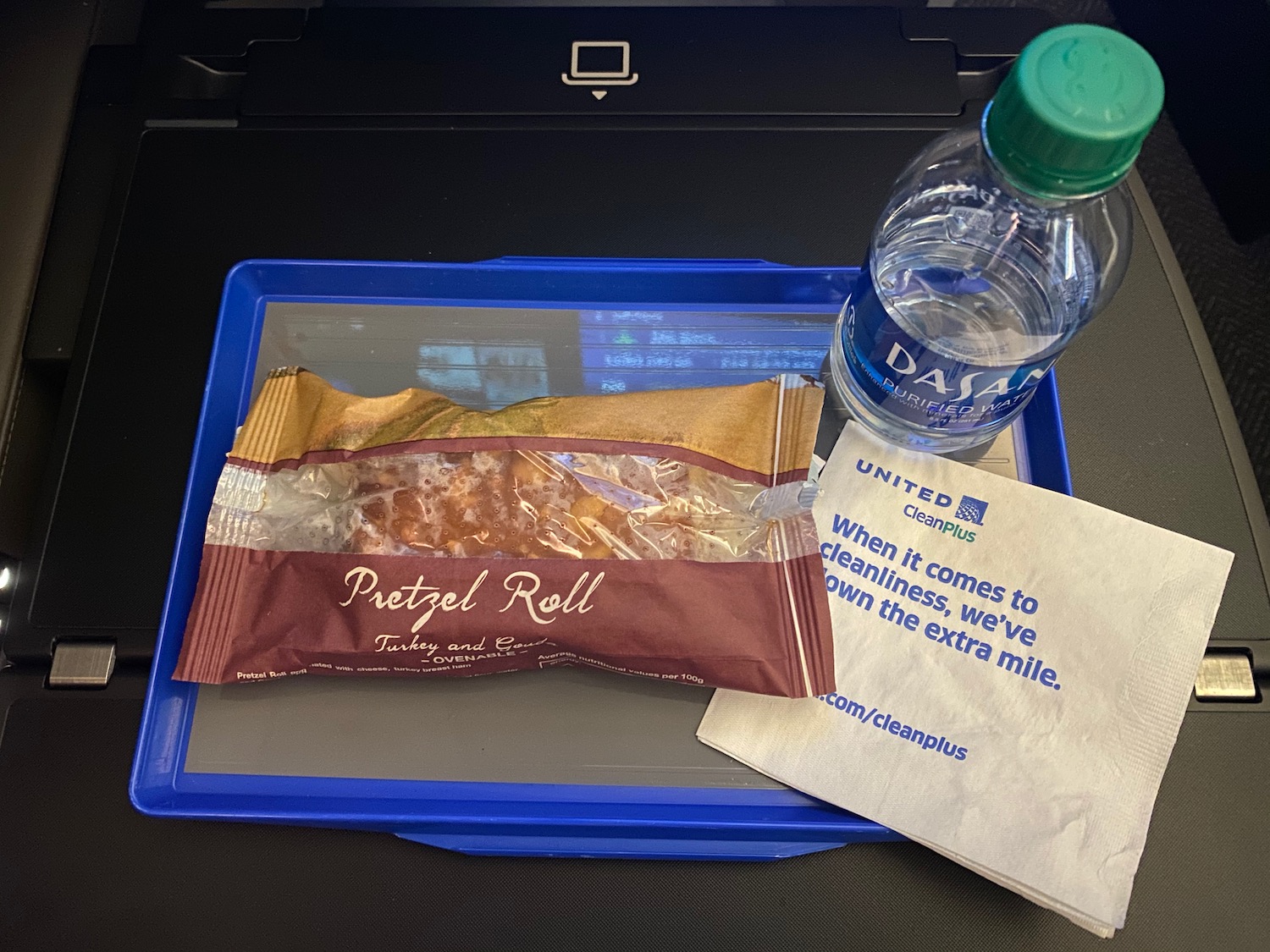 a plastic tray with food and a bottle of water