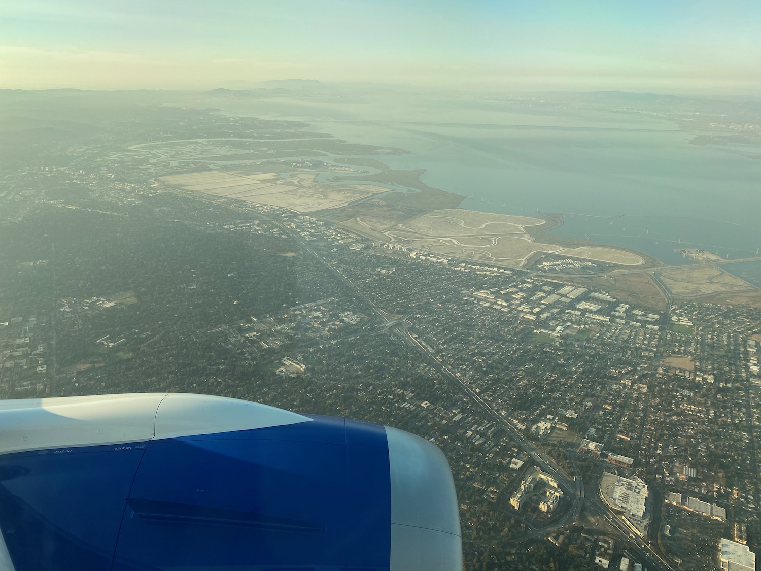 an airplane wing and a city