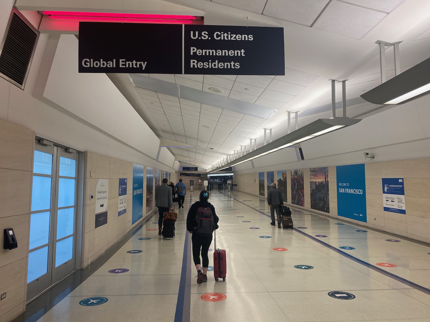 a person with luggage walking in a hallway