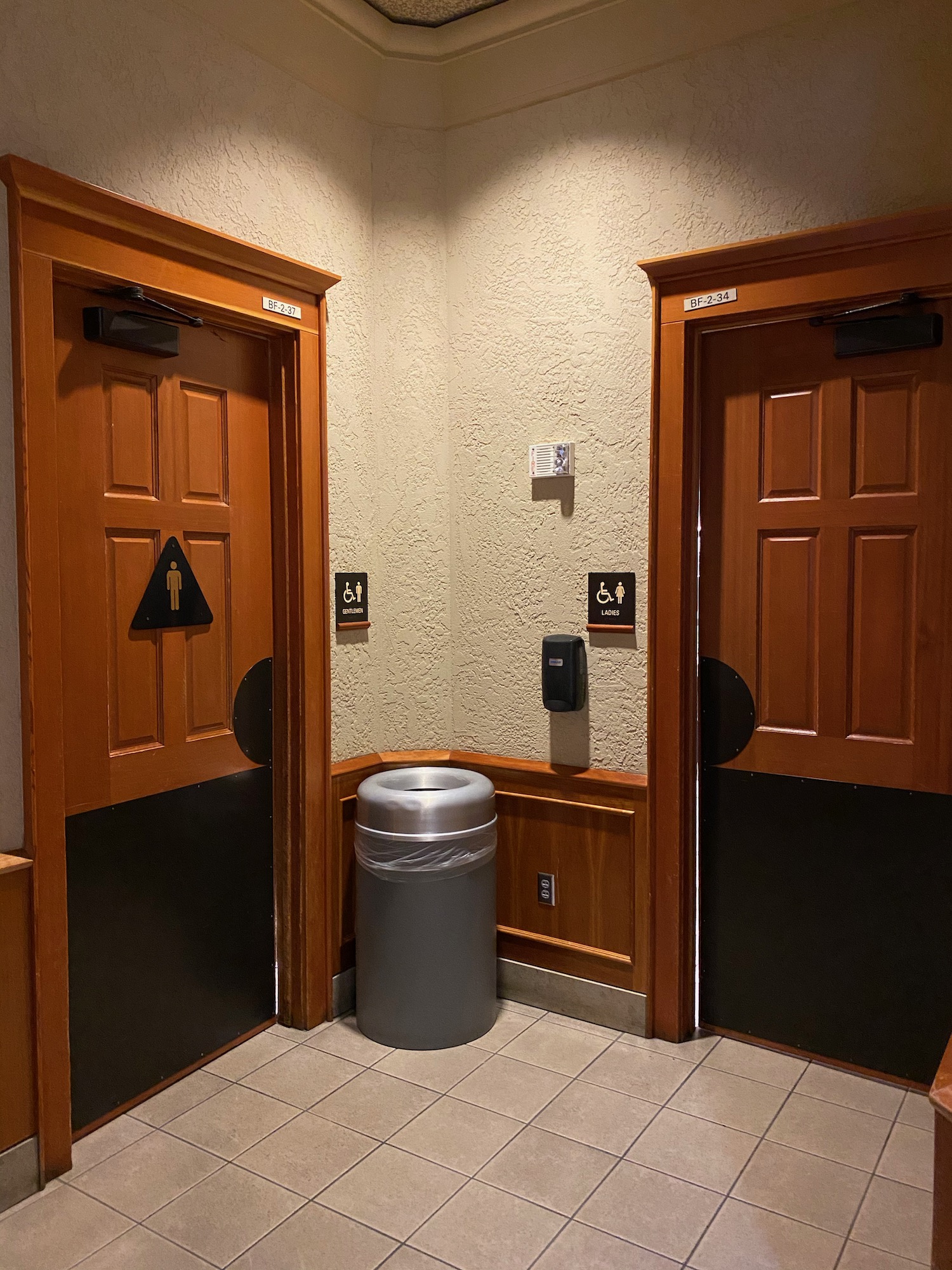 a two doors with a trash can