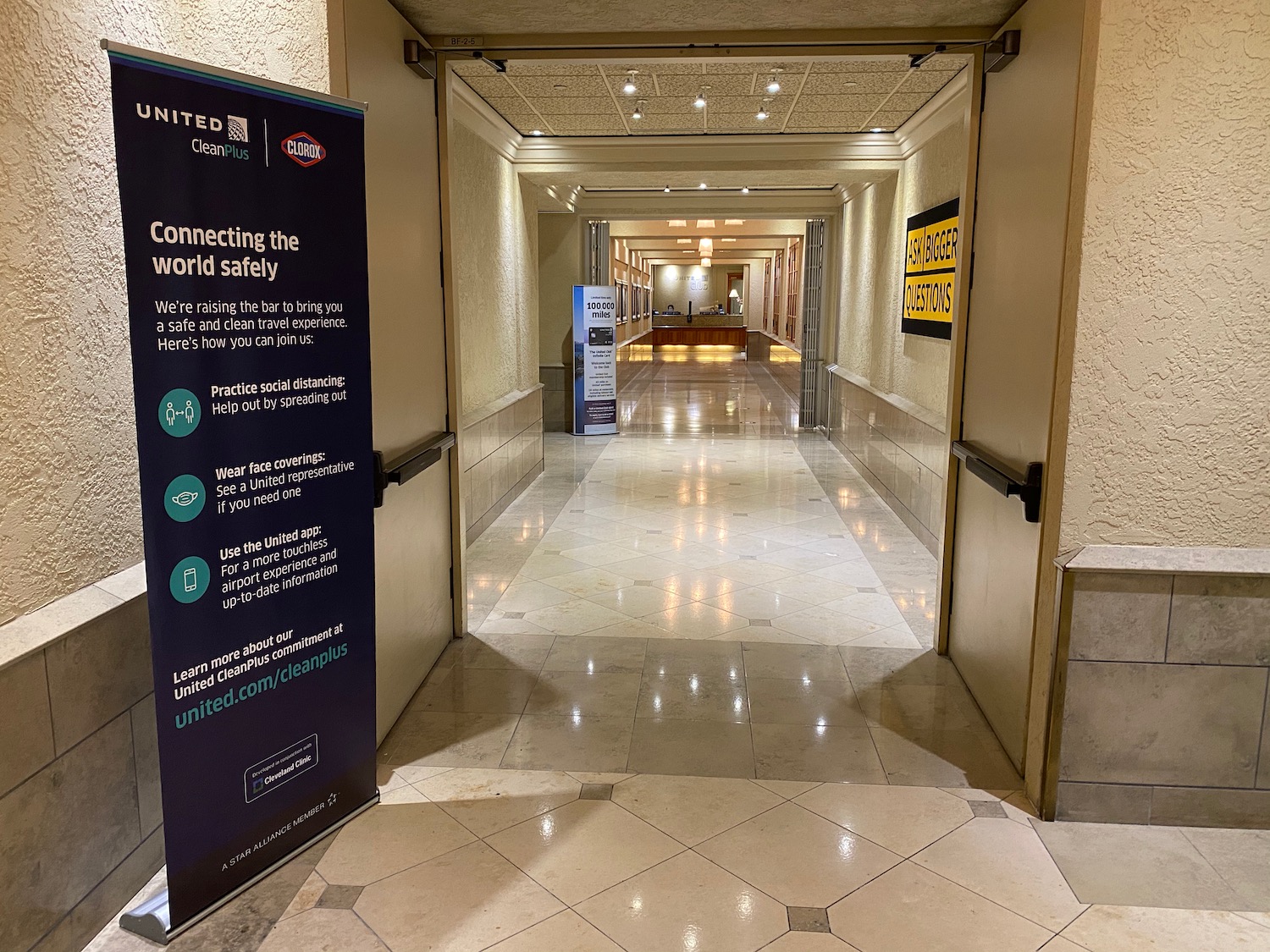 a hallway with a sign and a reception desk