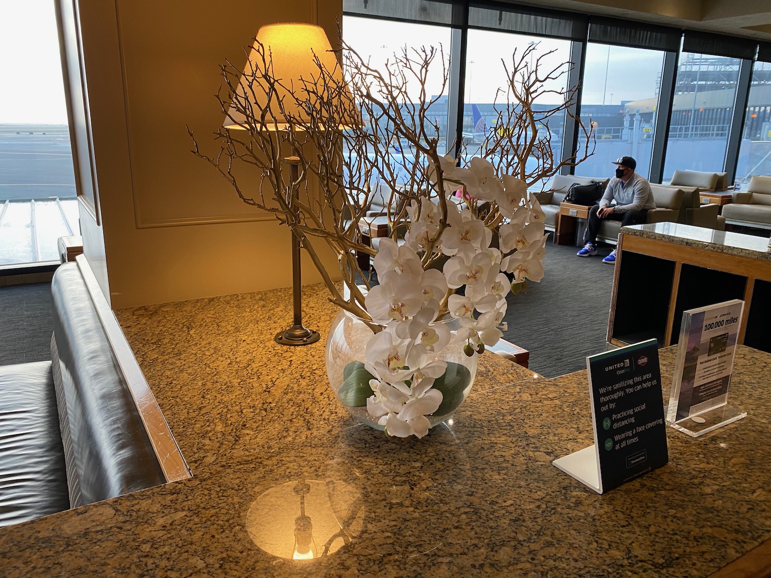 a vase with white flowers on a marble counter