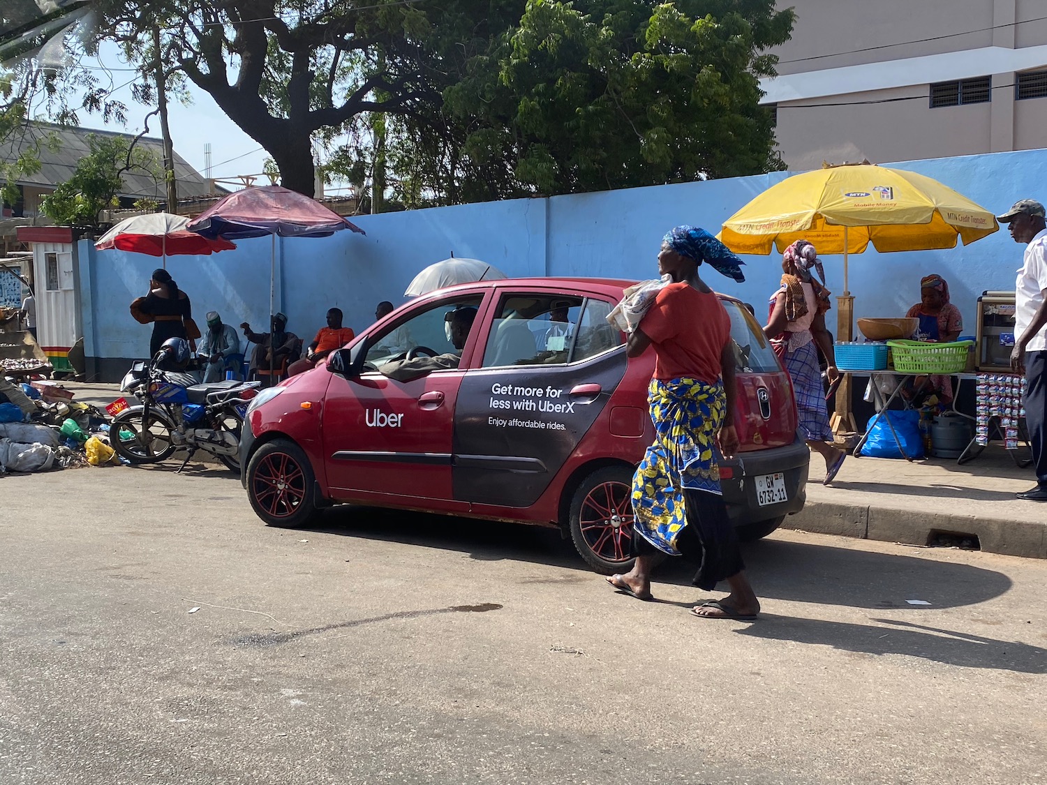 a woman walking next to a car