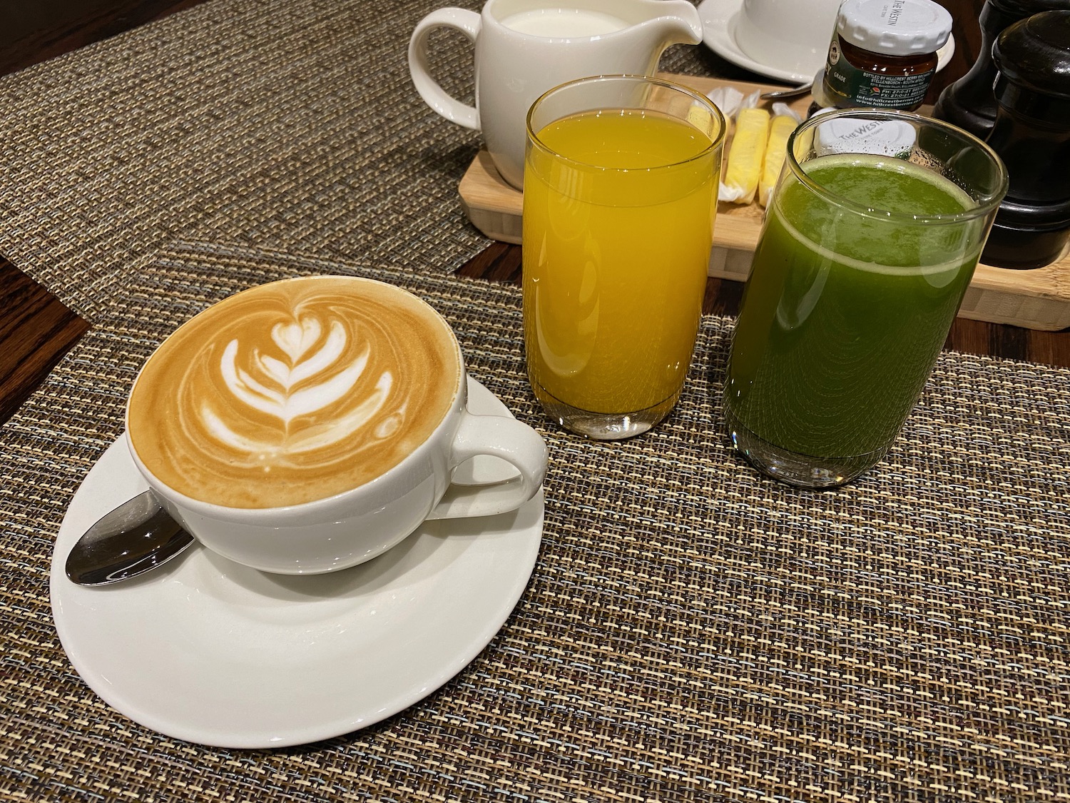a cup of coffee and juice on a table