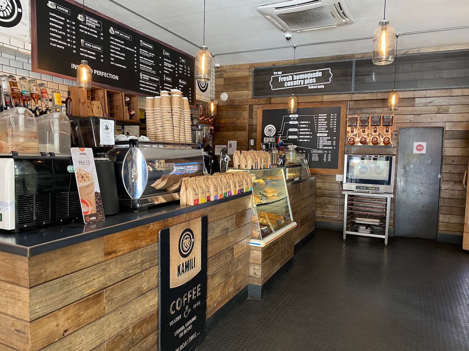 a coffee shop with wood walls and shelves