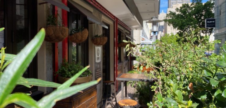 a building with plants and tables