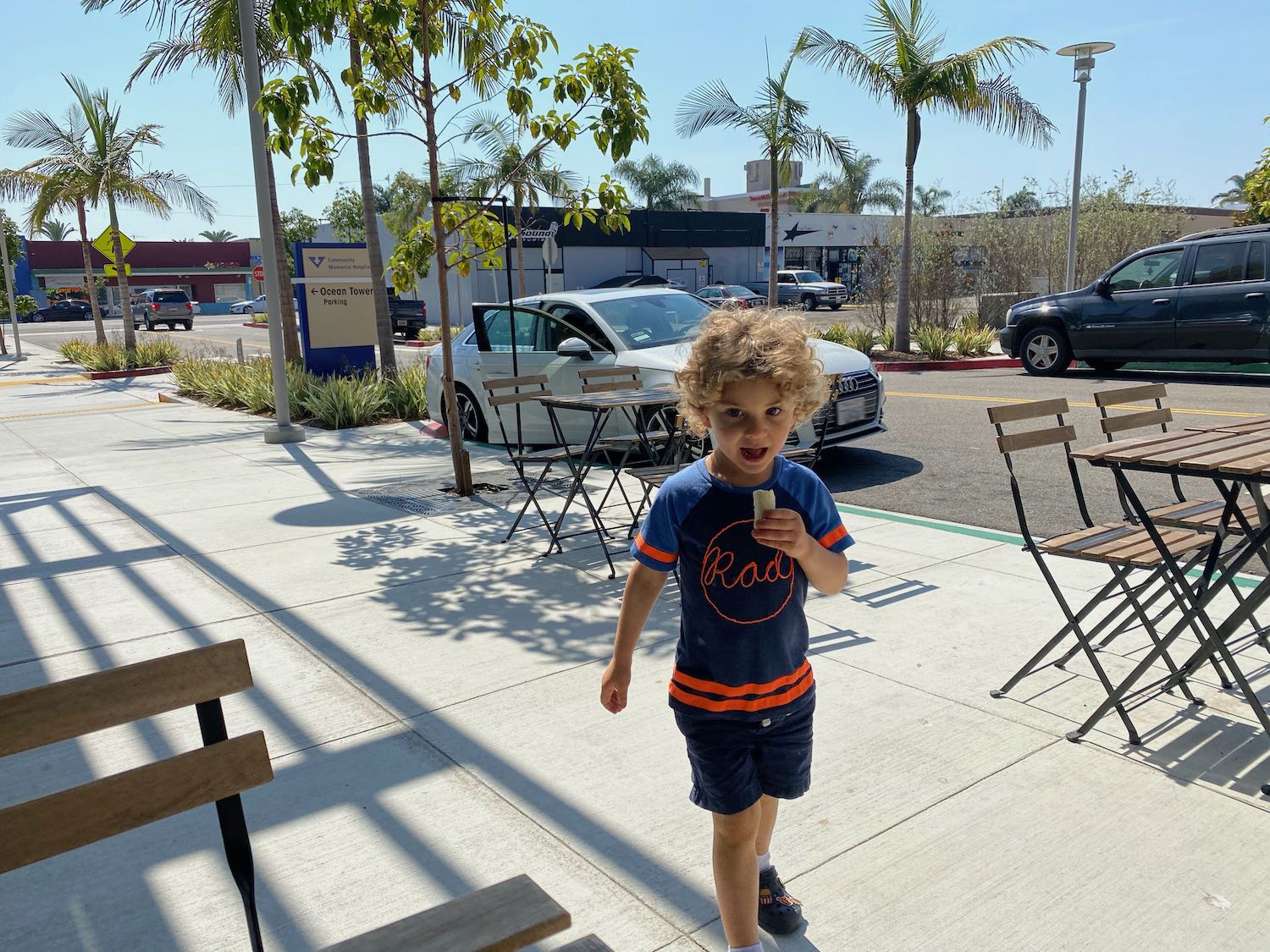 a boy walking on a sidewalk