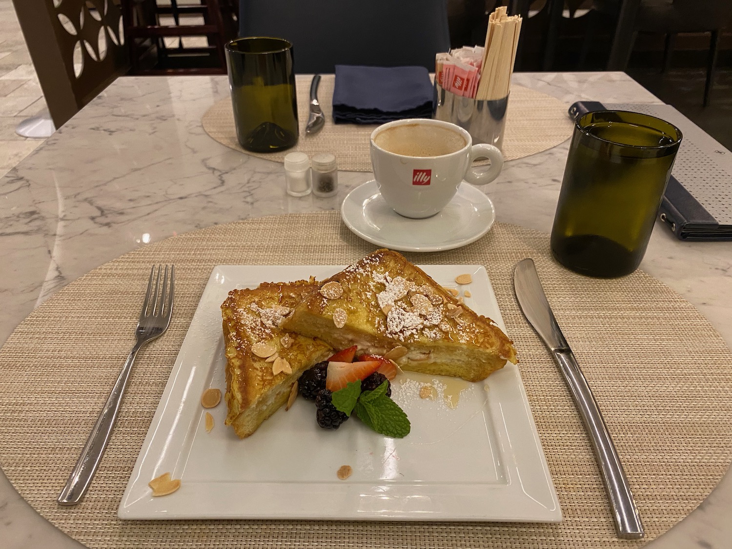 a plate of food and a cup of coffee on a table