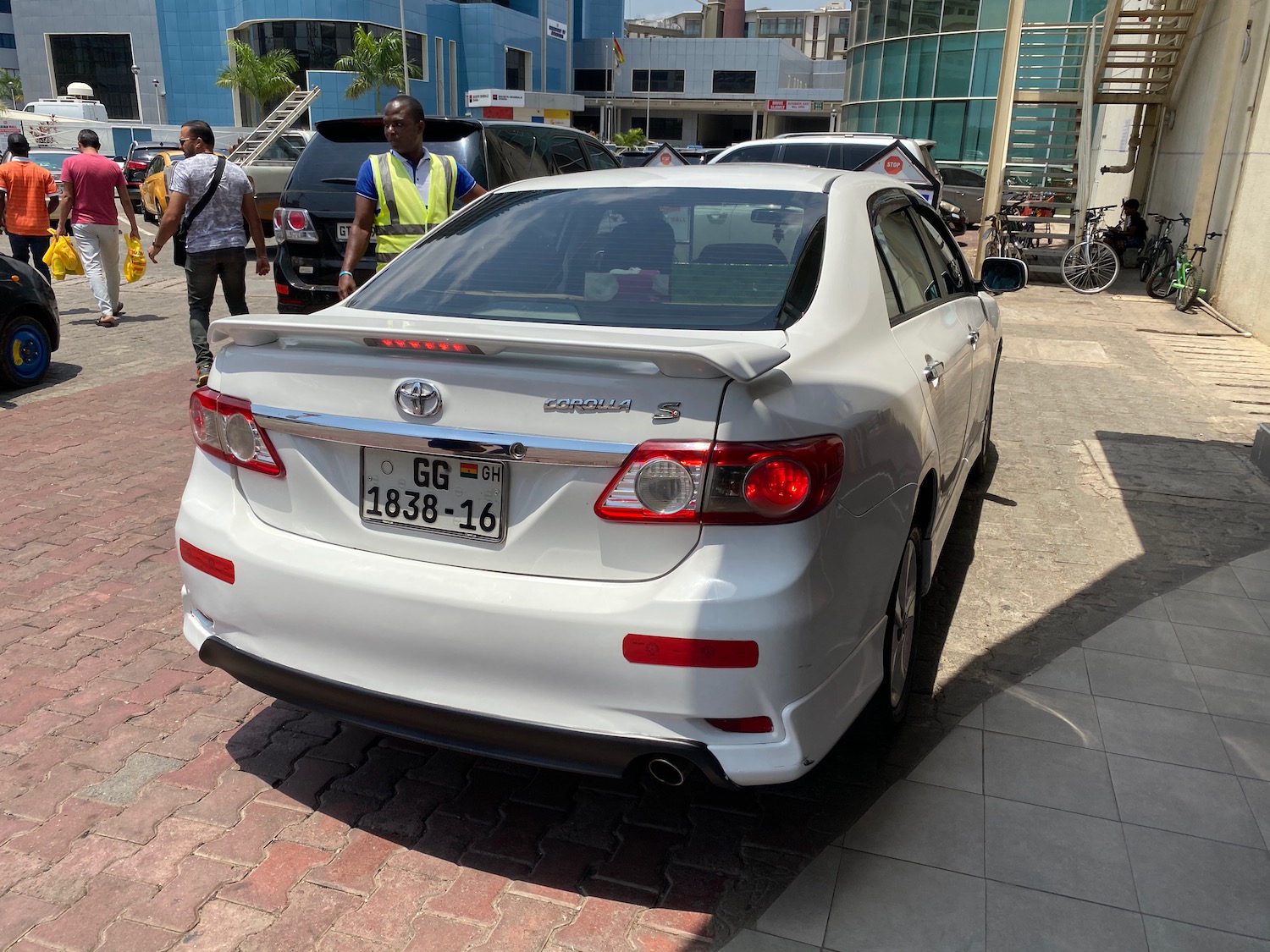 a white car parked on a brick road