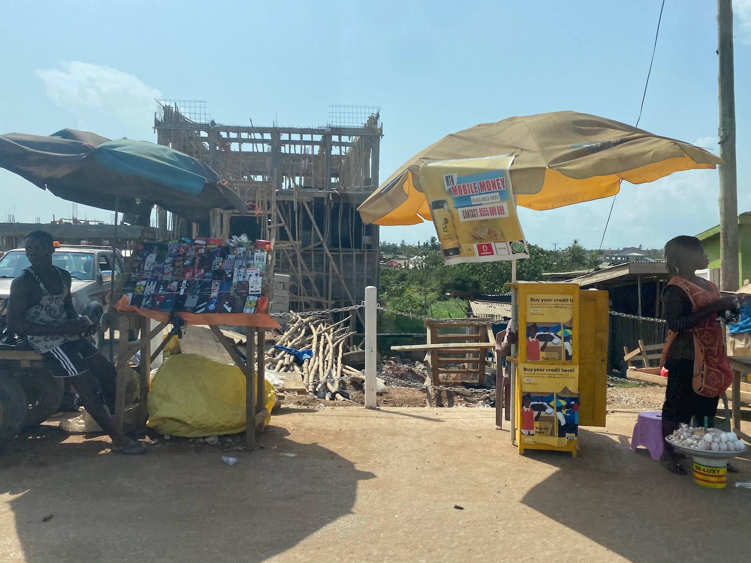 a wooden structure with a sign and umbrellas