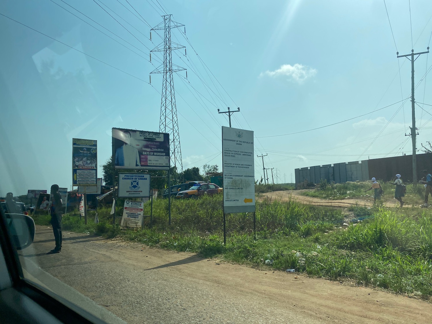 a road with signs and power lines