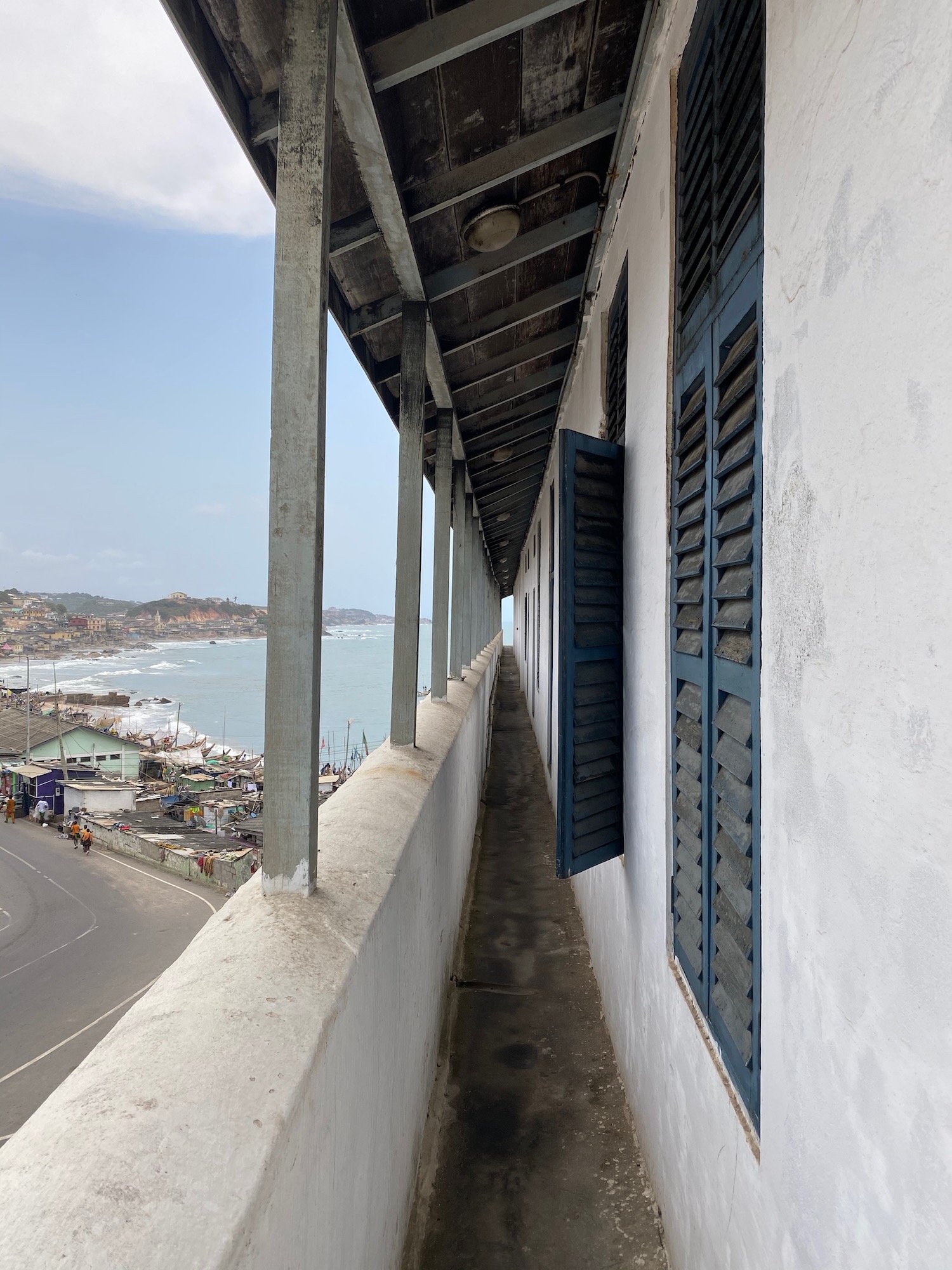 a building with a view of the ocean and a street