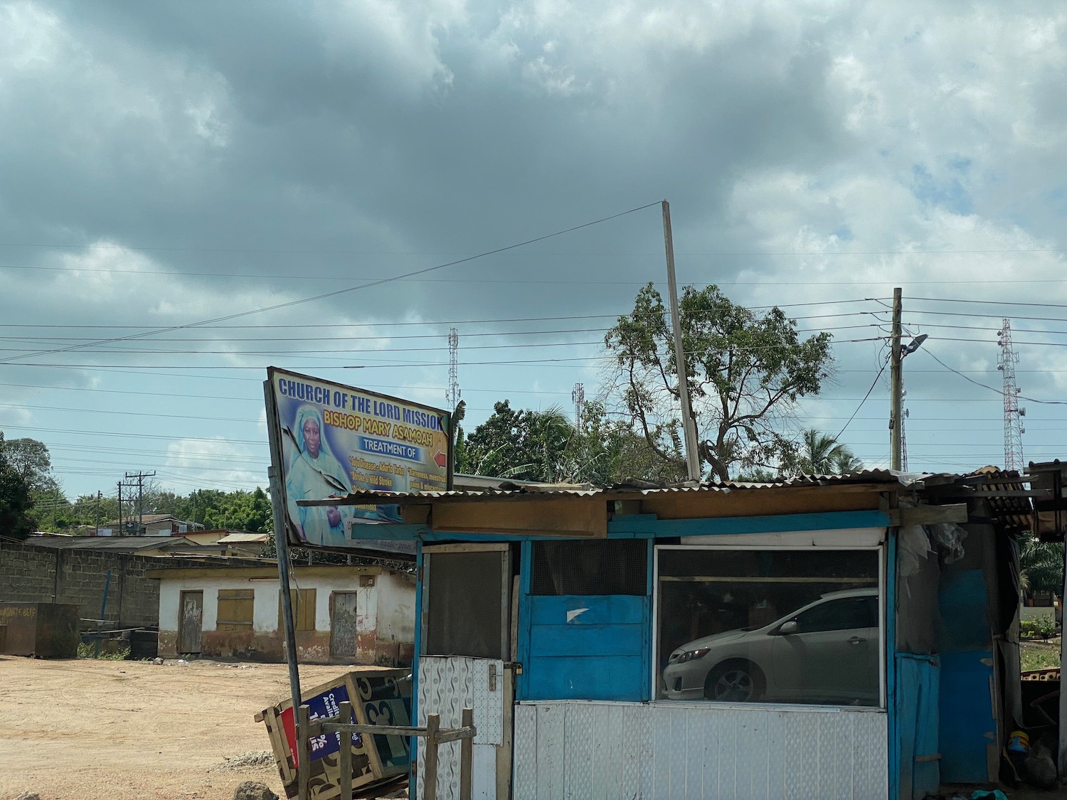 a small shack with a car parked in front of it