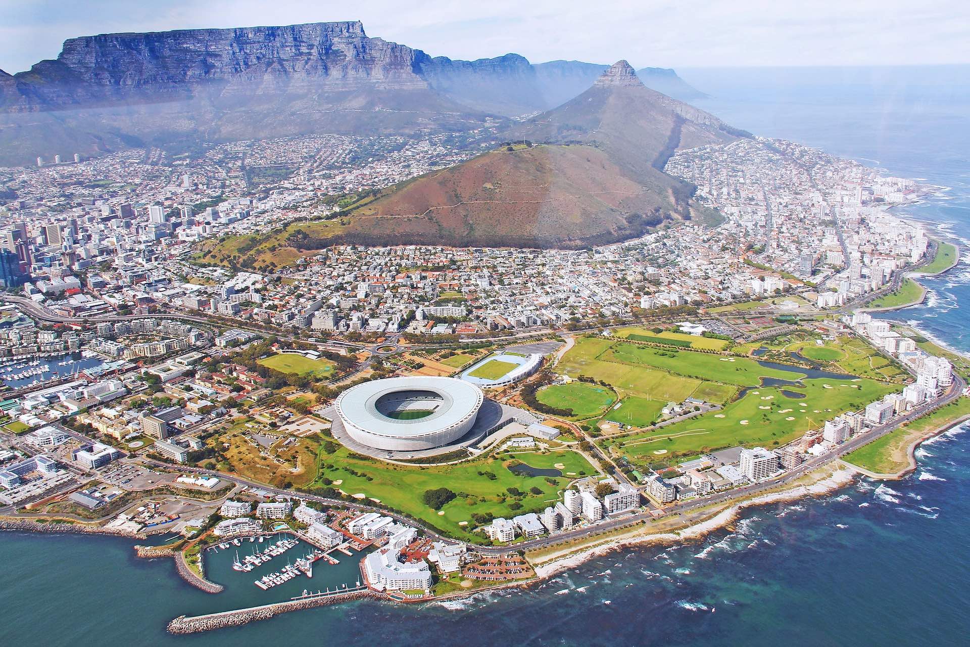 a aerial view of a city and a mountain