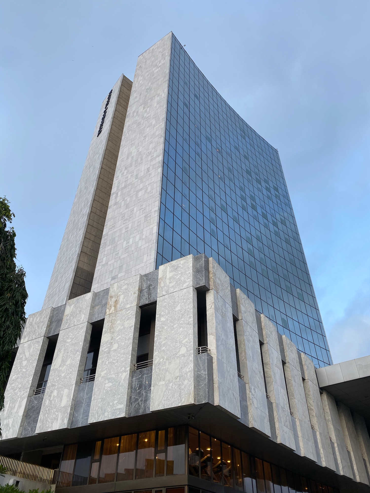 a tall building with a stone wall