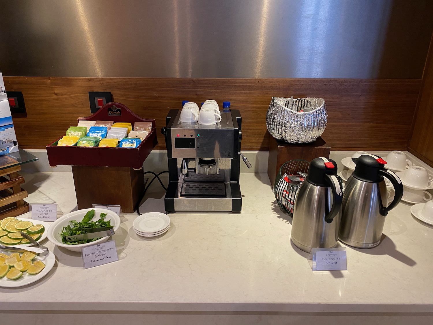 a coffee machine and a container of food on a counter