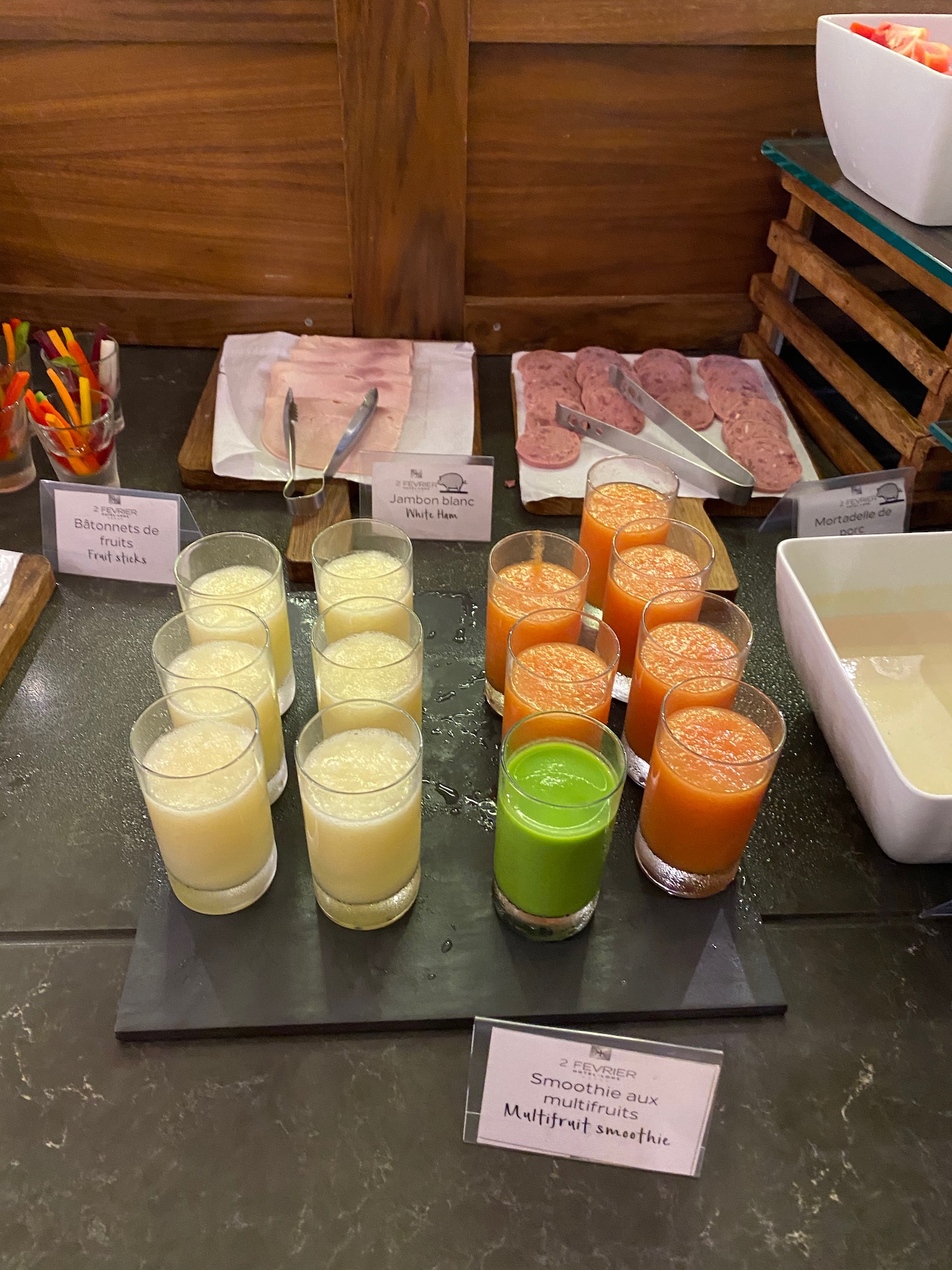 a table with glasses of juice and food