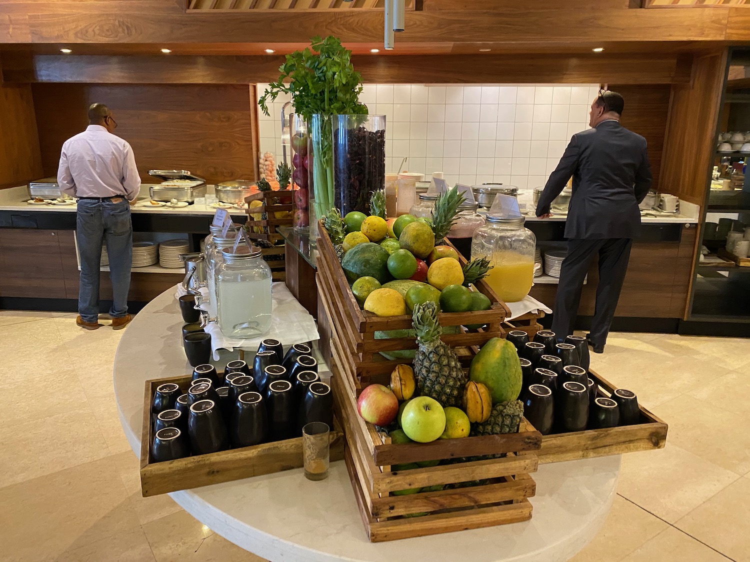 a buffet table with fruit and drinks