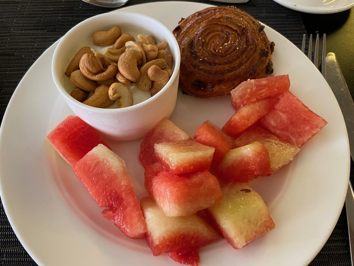 a plate of food with watermelon and fruit