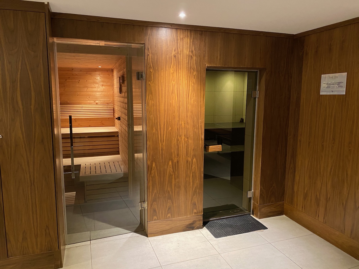 a wooden room with a glass door and a sauna