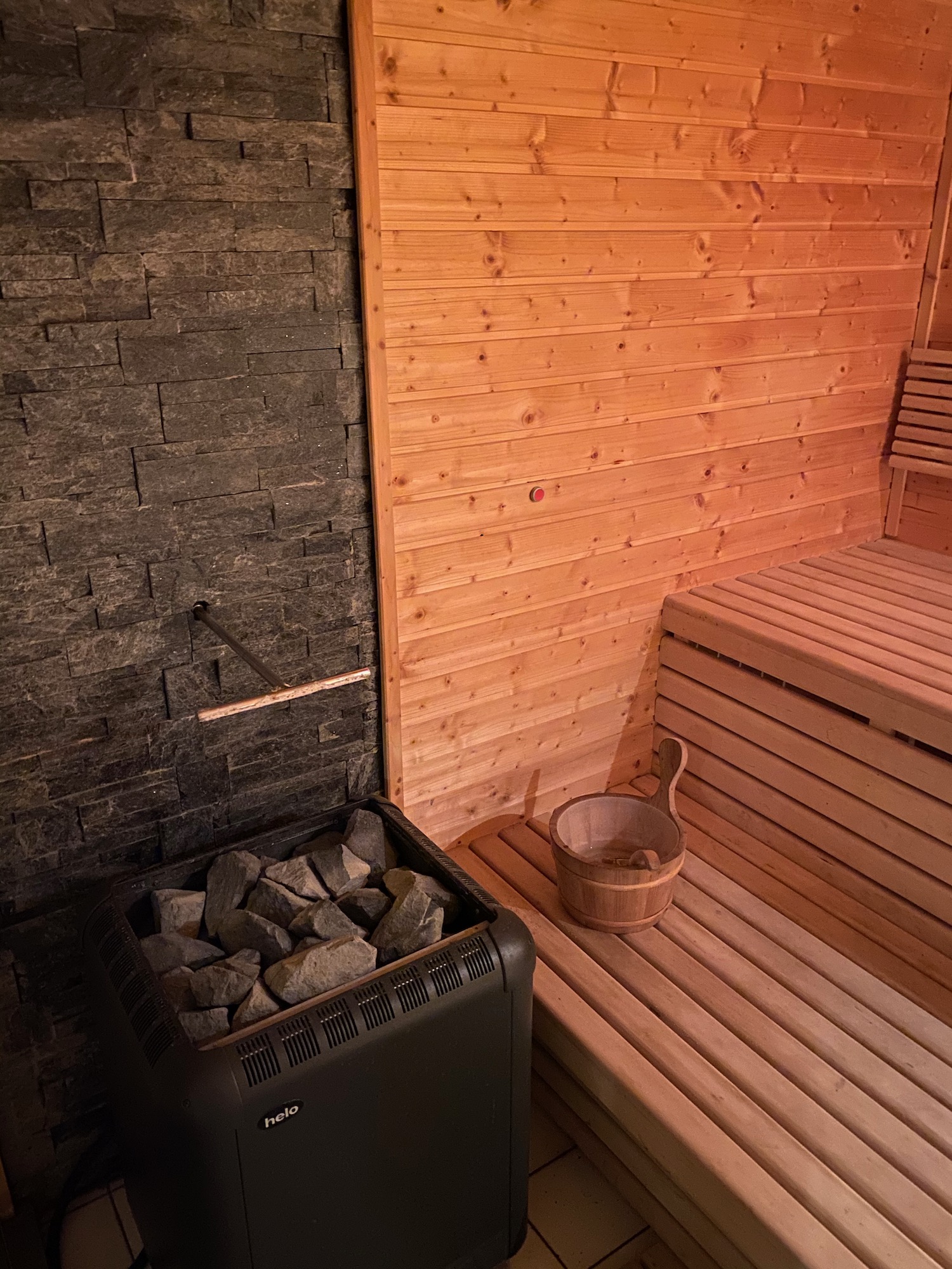 a sauna with a bucket of rocks