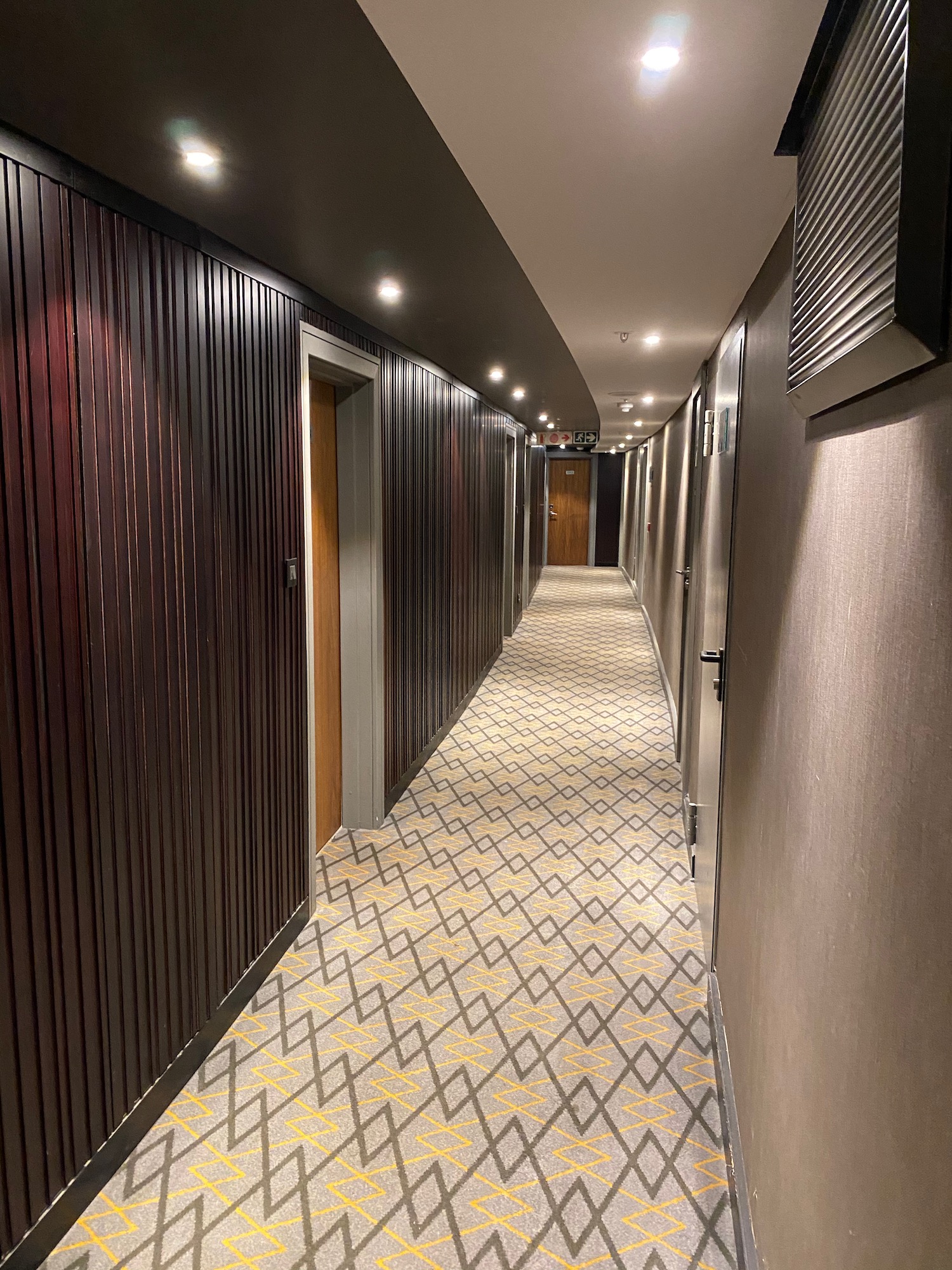 a hallway with doors and a carpet