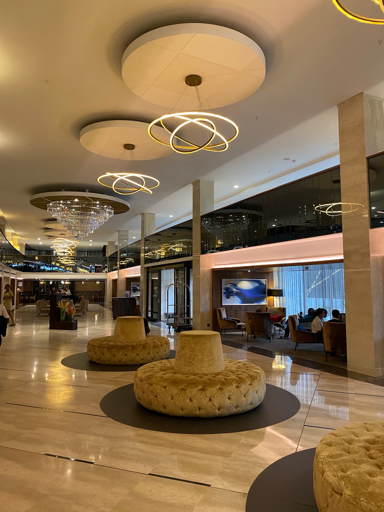 a large lobby with a chandelier and chairs