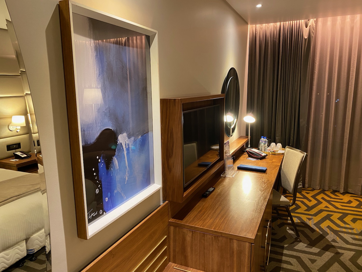 a room with a television and a mirror