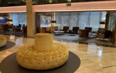 a large round yellow cushion in a lobby