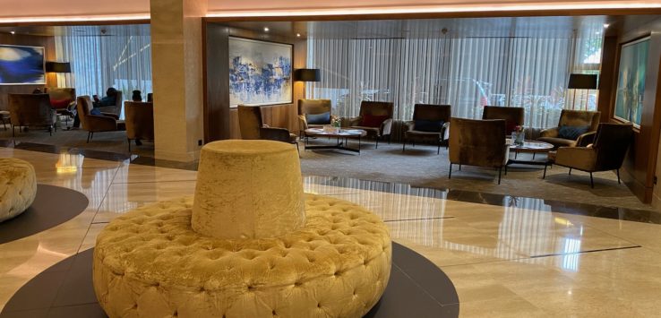 a large round yellow cushion in a lobby