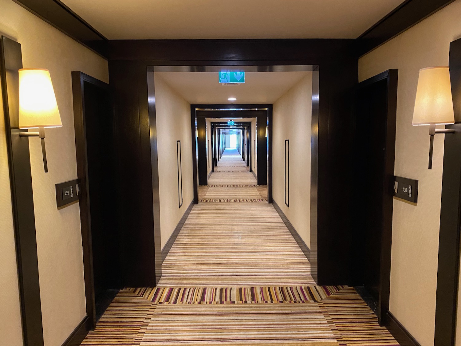 a hallway with a green sign