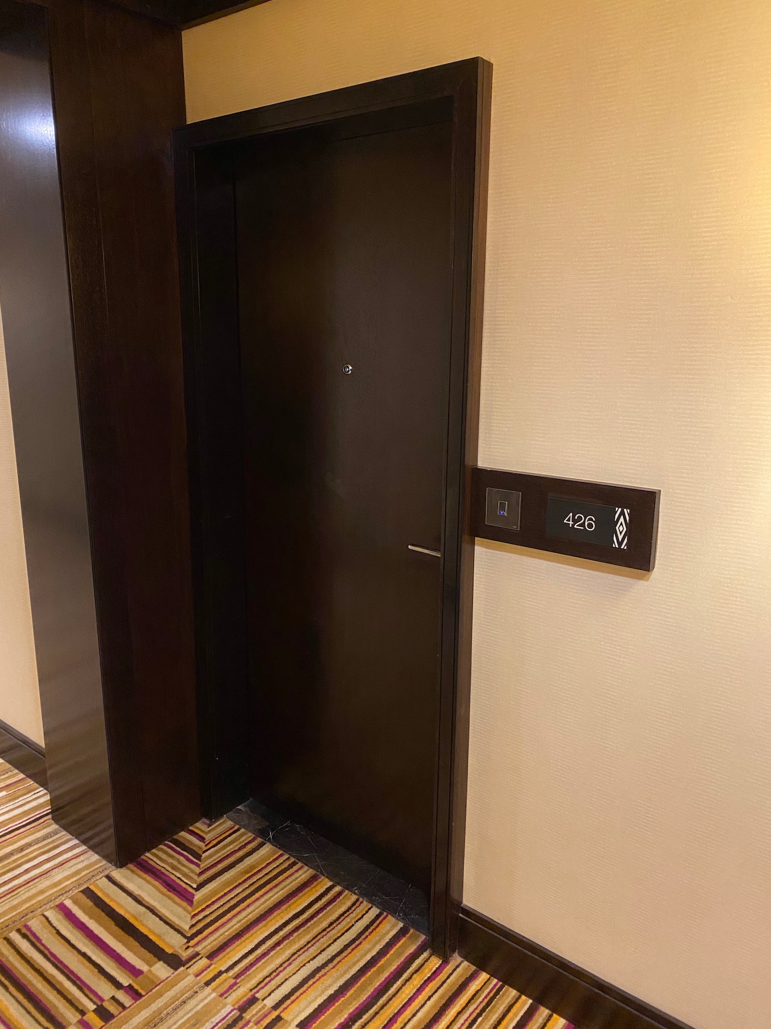an elevator door with a button on the wall