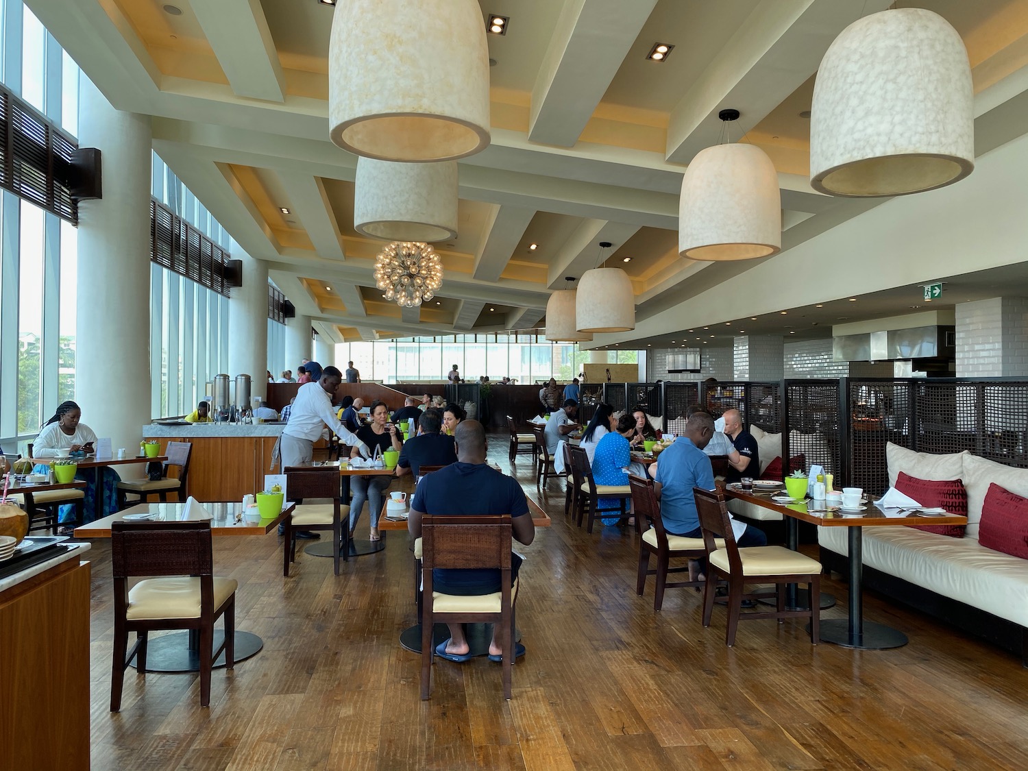 a group of people sitting at tables in a restaurant