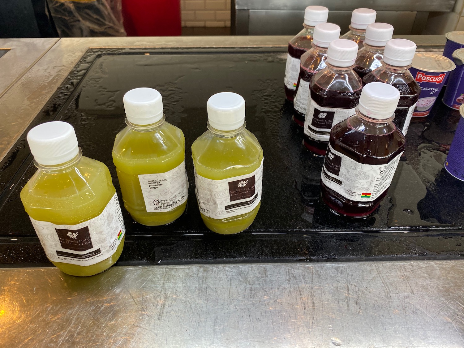 a group of bottles of juice on a black surface