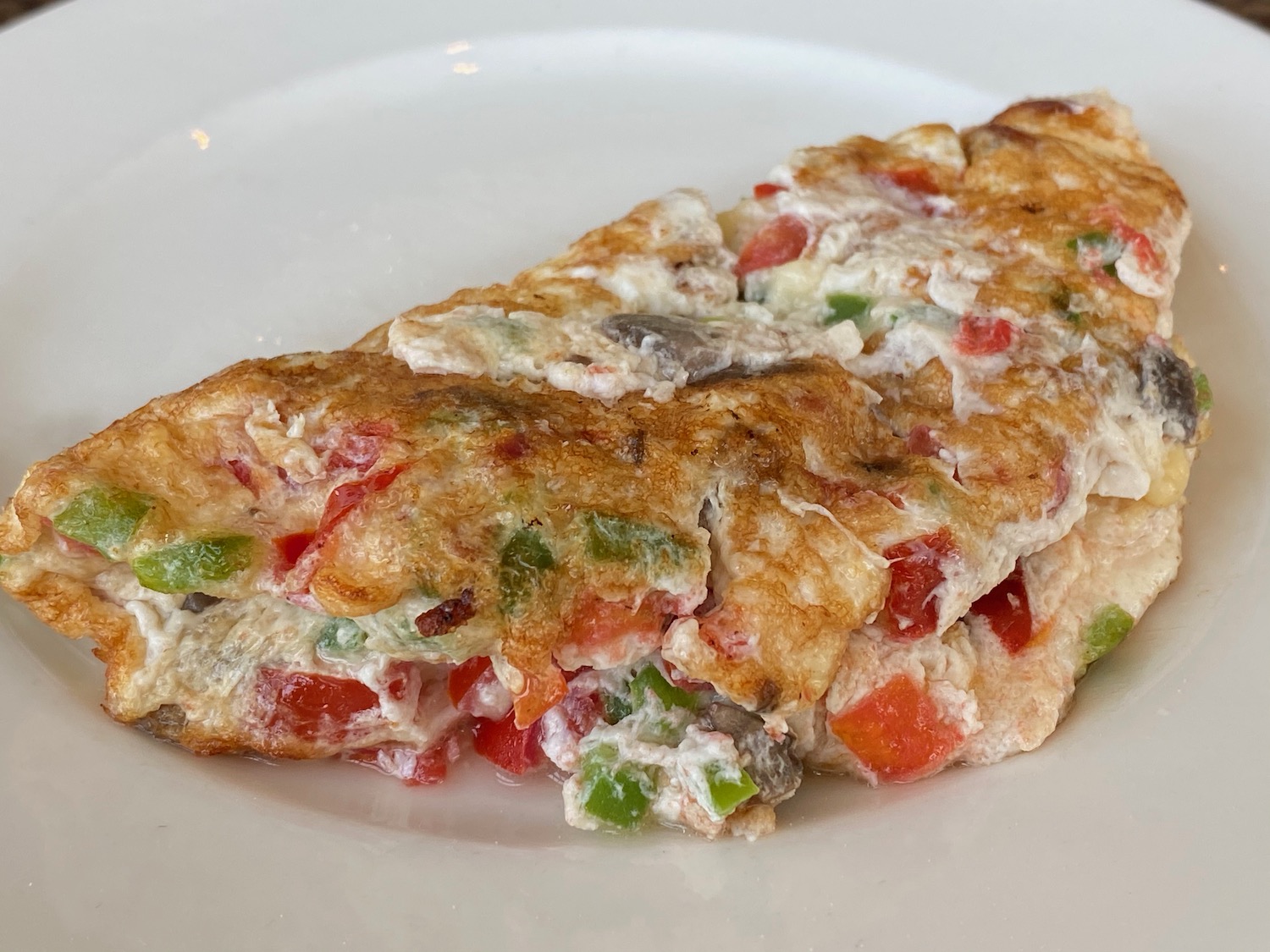 a plate of omelette with vegetables