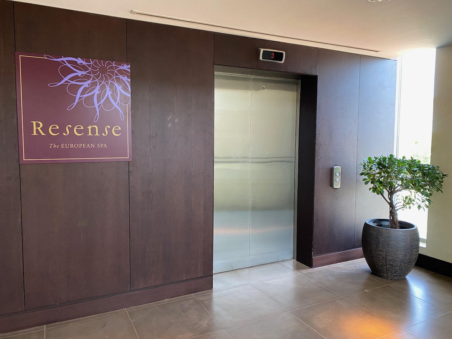 a elevator with a sign and a potted plant