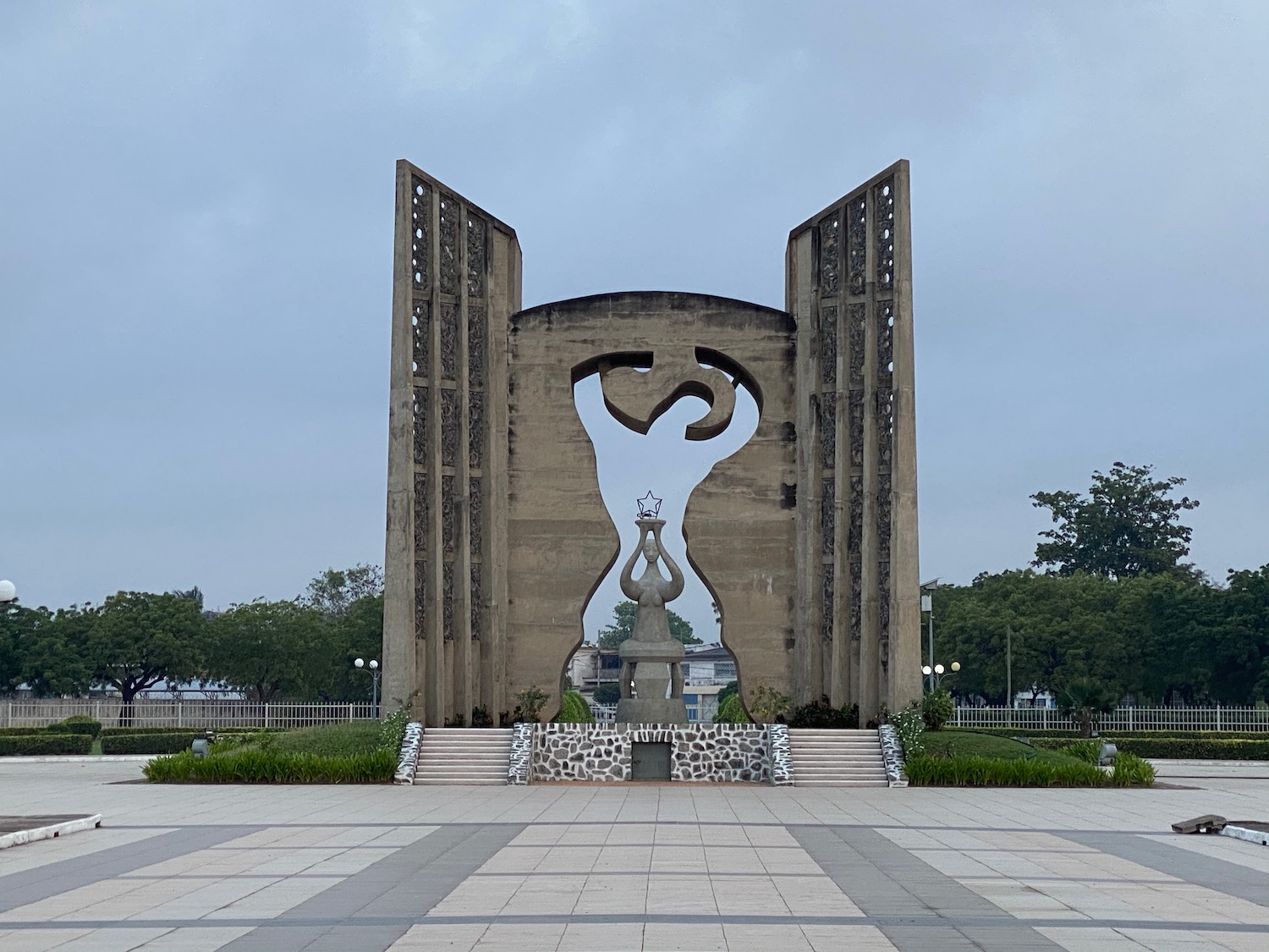 a stone structure with a statue in the middle of it