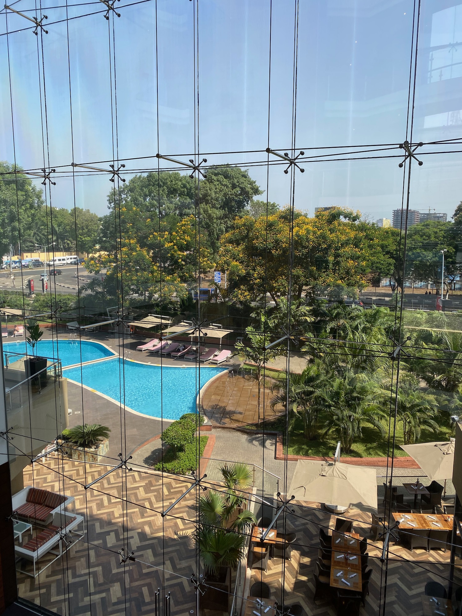 a pool and trees seen through a window