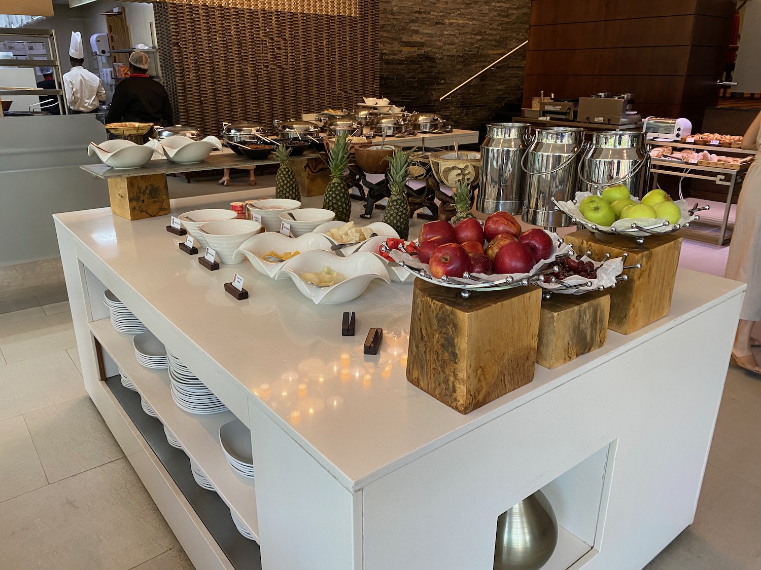 a buffet table with fruit and plates on it