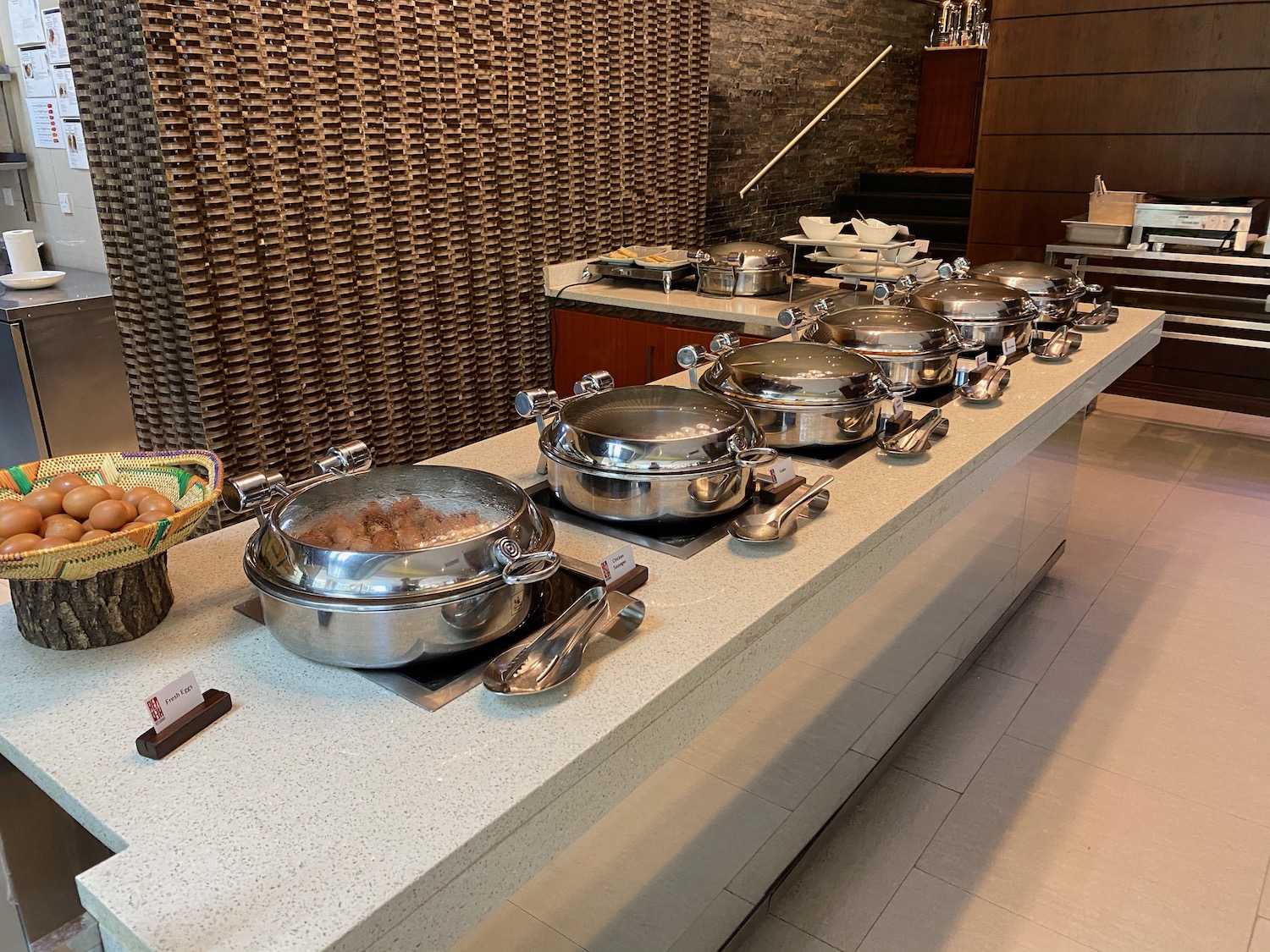 a row of silver pots on a counter