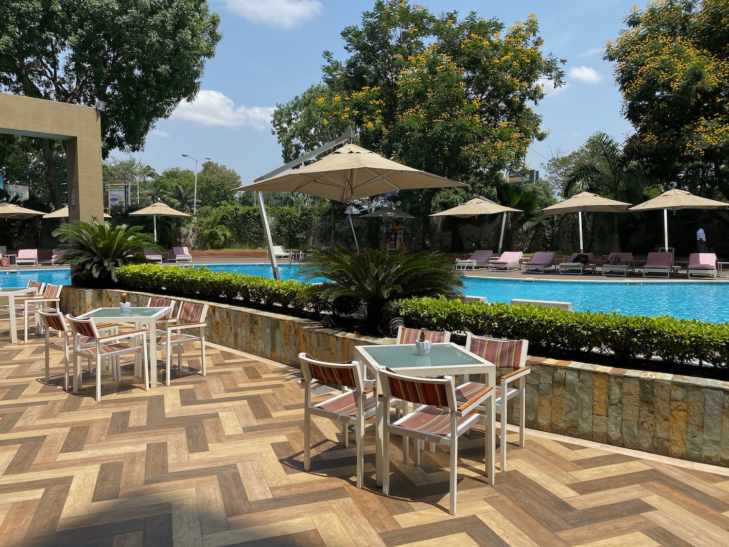 a pool with chairs and tables