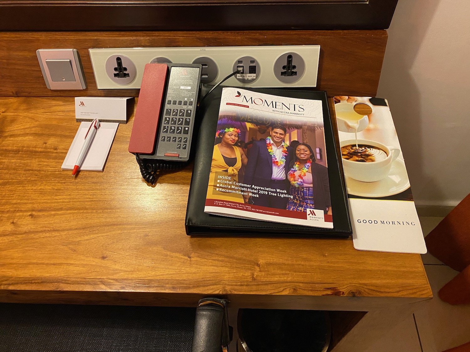 a phone and magazine on a desk